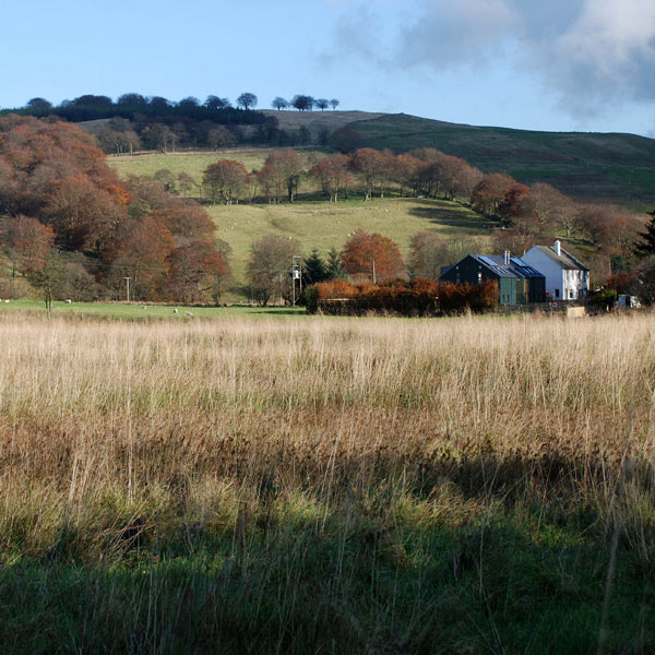view of the two semi-detached homes from across the fields of the Carron valley, near Denny in Central Scotland.