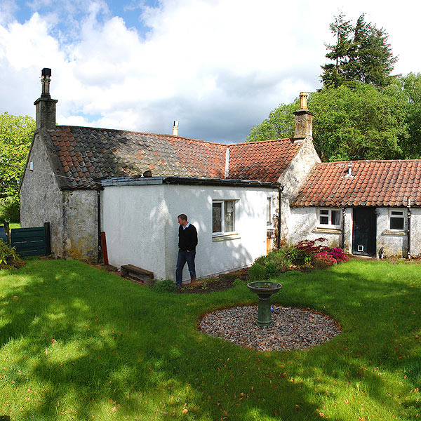 View of the cottage from the South-East showing the enclosed garden and the 1970's extension in white which will be removed as part of the overall upgrading works.